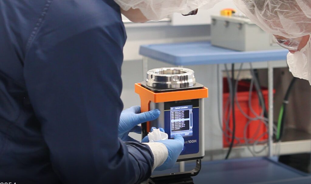 Over the shoulder image of an engineer in safety gear working