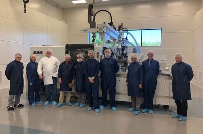 Group photo of workers taken during a tour of the facility